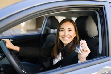 Beautiful woman in her 30s holding her new car keys