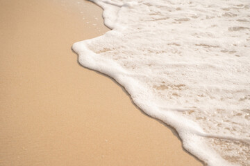 Fototapeta na wymiar White sea waves bubble On the brown sandy beach.soft focus.