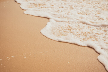White sea waves bubble On the brown sandy beach.soft focus.