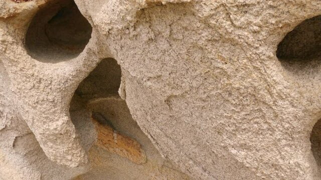 Up close view of holes and pattern in the granite rock formations at the Devils Tower in the Utah Desert.