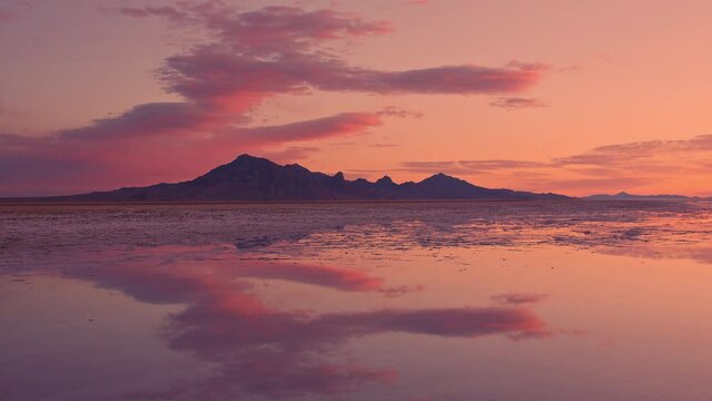 Timelapse of colorful sunrise over the Great Salt Lake as water covers the Bonneville Salt Flats in Utah.