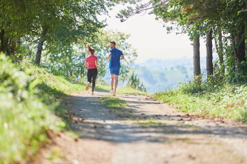 Fototapeta na wymiar couple enjoying in a healthy lifestyle while jogging on a country road
