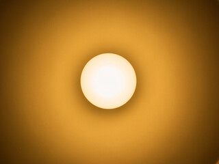 Yellow lightbulb on ceiling