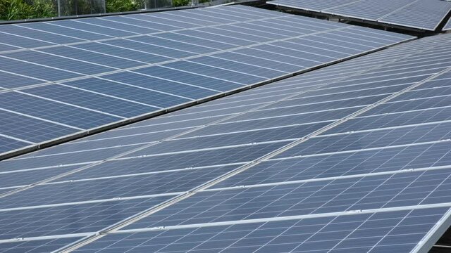 Tilting 4k Footage Of A Row Of Solar Panels On An Industrial Building