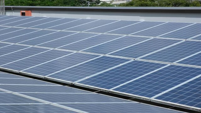 Panning 4k Footage Of A Row Of Solar Panels On An Industrial Building