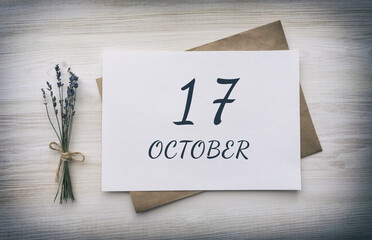 october 17. 17th day of the month, calendar date.White blank of paper with a brown envelope, dry bouquet of lavender flowers on a wooden background. Autumn month, day of the year concept
