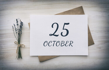 october 25. 25th day of the month, calendar date.White blank of paper with a brown envelope, dry bouquet of lavender flowers on a wooden background. Autumn month, day of the year concept
