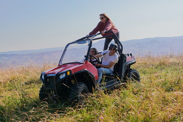 Fototapeta na wymiar group young happy people enjoying beautiful sunny day while driving a off road buggy car