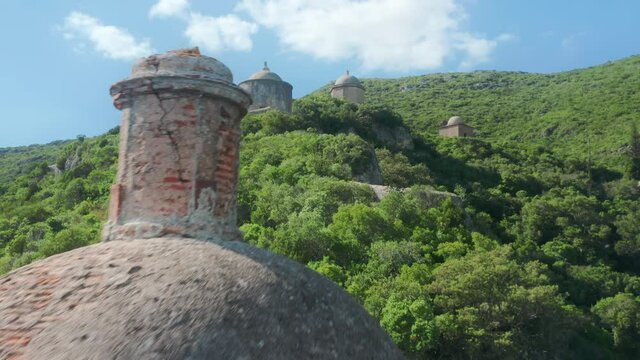 Arrabida, Portugal. Aerial footage of the Arrabida Fortification on green hills. Monumental landmarks with round domes under the blue clear sky. High quality 4k footage