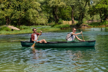 friends are canoeing in a wild river