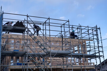 A worker at the housing construction site with wooden Framework construction, TOKYO, JAPAN - 18TH FEB 2021.