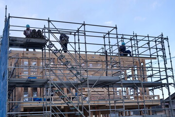 A worker at the housing construction site with wooden Framework construction, TOKYO, JAPAN - 18TH FEB 2021.