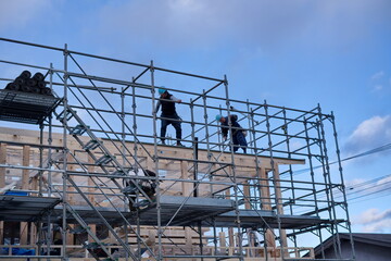 A worker at the housing construction site with wooden Framework construction, TOKYO, JAPAN - 18TH FEB 2021.