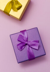 boxes for presentations of different colors on a pink background. Festive backdrop for holidays: Birthday, Valentines day, Christmas, New Year.
