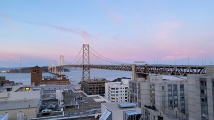 View of the San Francisco Bay Bridge from the East Cut (South of Market Street) neighborhood of San Francisco during sunset in the Spring of 2021.