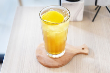 Peach tea with ice served on the table.