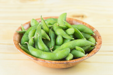 green soybeans on wood background