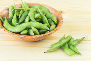 green soybeans on wood background