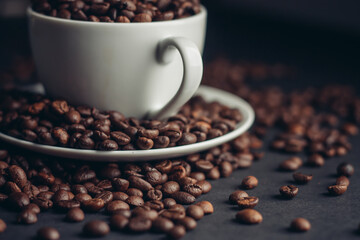white cup with coffee beans on gray background Arabica variety