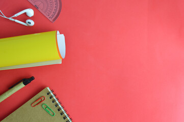 Stationery tools over red background with copy space