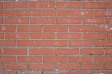 Obraz premium A wall with a crack of red brick, laid horizontally. Texture for the background.
