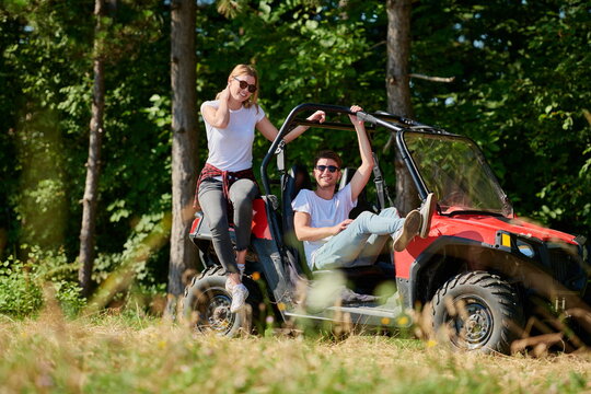 couple enjoying beautiful sunny day while driving a off road buggy