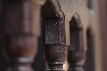 The art of carving wood fence details with macro and blur look and dark brown wood color