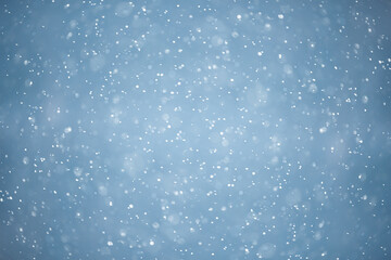 blue snowfall bokeh background, abstract snowflake background on blurred abstract blue