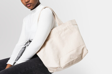 Woman with white tote bag
