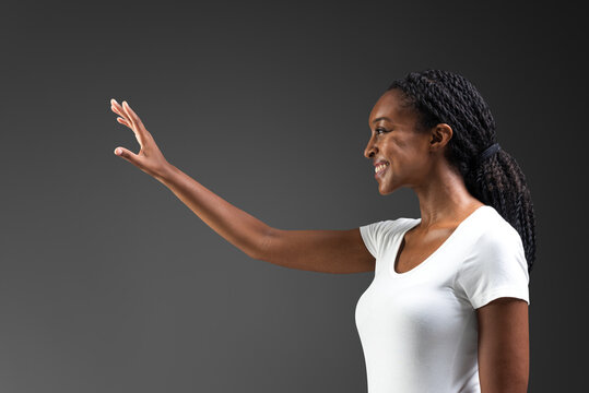 Woman reacing out and touching invisible screen