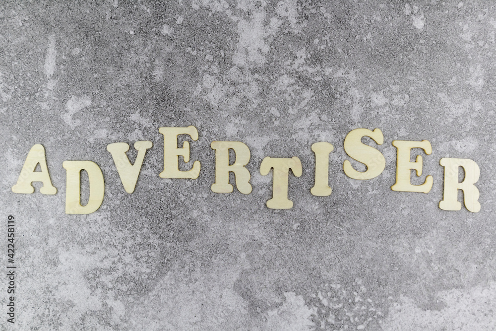 Fototapete Advertiser concept with decorative alphabet letters in an undulating line on a textured grey background viewed as a flat lay with copyspace