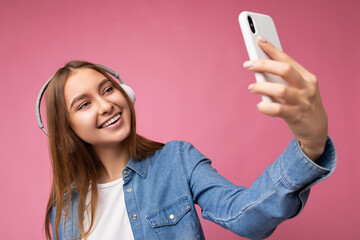 Photo shot of beautiful joyful smiling young female person wearing stylish casual outfit isolated...