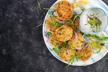 Homemade fish croquette with white fish, bulgur, spinach and breadcrumbs. Fritters from minced cod. Delicious and nutritious lunch or dinner. Top view, overhead