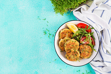 Homemade fish croquette with white fish, bulgur, spinach and breadcrumbs. Fritters from minced cod. Delicious and nutritious lunch or dinner. Top view, overhead