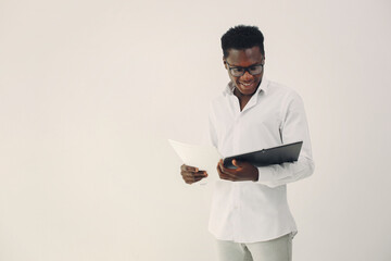 Handsome black man standing on a white background