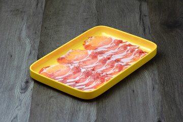 fresh raw pork, meat ,beef, belly, sliced on square plate  on wood, wooden background,set shabu, hot pot ingredients.