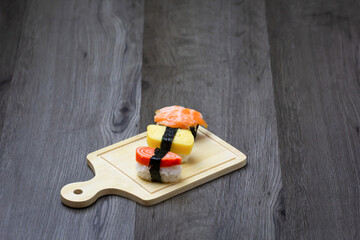 Sushi Set sashimi and sushi rolls served on wood background