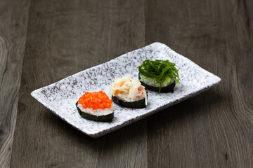 Sushi Set sashimi and sushi rolls served on wood background