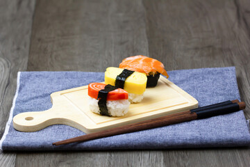 Sushi Set sashimi and sushi rolls served on wood background