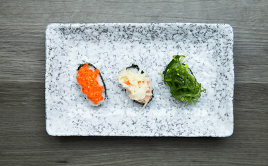 Sushi Set sashimi and sushi rolls served on wood background