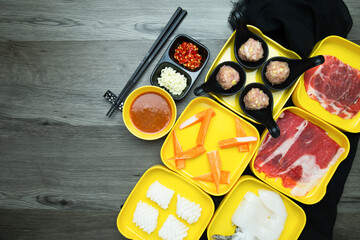 fresh raw pork, meat ,beef, belly,crab stick sliced on square plate  on wood, wooden background,set shabu, hot pot ingredients.