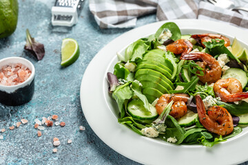 plate of fresh salad with shrimps, avocado, blue cheese mixed greens. Healthy food. Clean eating. place for text, top view