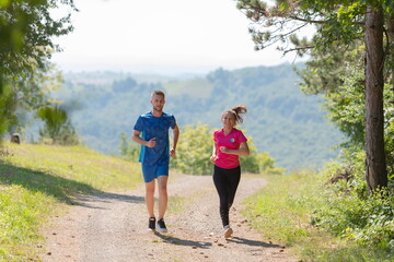 couple enjoying in a healthy lifestyle while jogging on a country road