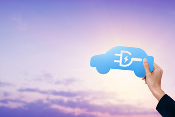 Hand holding blue electric car icon at sky
