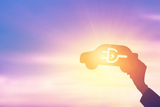 Silhouette hand holding electric car icon - Powered by Adobe