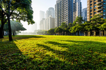 view of park green space and modern buildings on both sides in downtown Taichung, Taiwan. near the...