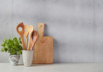 Wooden cutting board, spoons and basil © goir