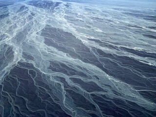 Dry riverbed lines in Nazca desert, aerial view.