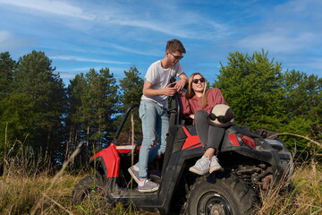 couple enjoying beautiful sunny day while driving a off road buggy