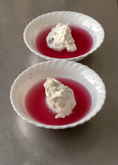 white bowl, cranberry jelly with cottage cheese cream, school feeding concept, lunch for students